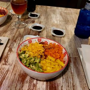 Poke bowl made vegan with mango, carrots, vegan cheddar, avocado and soy sauce or sriracha mayo (instead of a tuna poke bowl) at Codigos del Arte in Denia