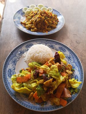 Stir fried veggies with tofu and rice 35k + curry fried rice in the background 35k at The Garden of Nang in Don Det