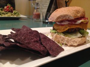 Macro Burger with cheez! Love everything about this meal. The chips were light and fresh, as well as the flavor was on point in the black bean/sweet potato, rice patty! at The Present Moment Cafe and Market in St Augustine