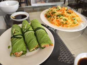 Mustard leaf rolls and papaya salad at Sesame in Hanoi