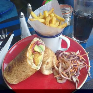 Vegan falafel and houmous wrap with added Avacado, fries and Vegan slaw   at Delfino Lounge in Poole