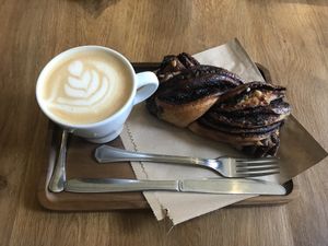 Oat milk latte and chocolate pastry at La Colectiva Cafe in Madrid