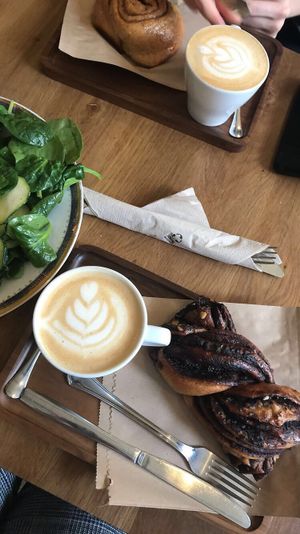 Lattes, cinnamon roll, chocolate twist, and salad  at La Colectiva Cafe in Madrid