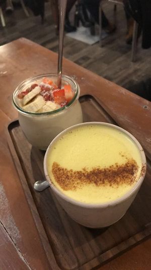 Turmeric latte and fruit yogurt at La Colectiva Cafe in Madrid