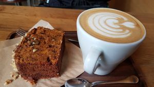Carrot cake and latte at La Colectiva Cafe in Madrid