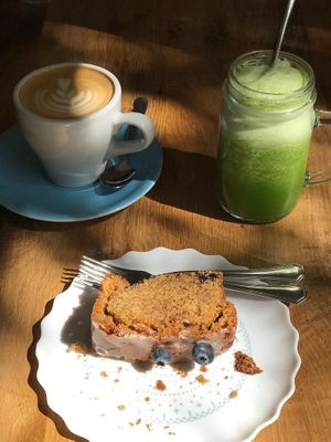 Delicious lemon blueberry cake, green juice and oat latte at La Colectiva Cafe in Madrid