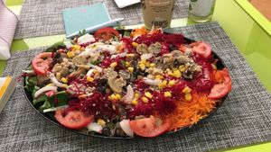 Huge salad with carrots, mushrooms, beets, corn, olives, mixed greens; onions, cucumbers and tomatoes  at Vegana By Tentúgal in Porto