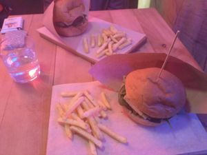 A papay burger and a cheeseburger (served with fries) at OM NOM NOM in Lviv