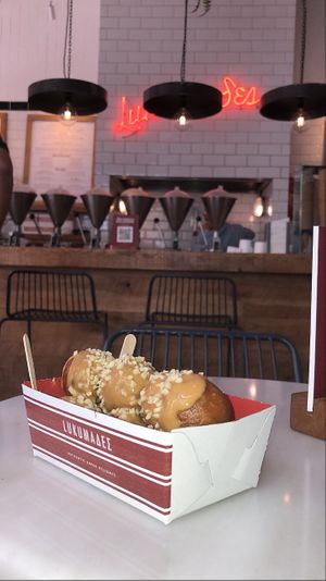 lukkamades filled with chocolate praline and topped with peanut butter and hazelnuts at Lukumades in Athens