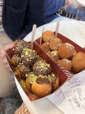Bitter chocolate and pistachios and cinnamon and walnut on the other   at Lukumades in Athens