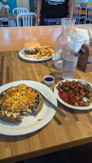 Mushroom waffle melt with a side of diced potatoes, and the hot Nashville sandwich at Off The Griddle - Southeast in Portland