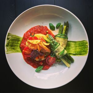 Zucchini-Asparagus-Rolls. Polenta. Pesto. Tomato-Sauce. Basil. Veggie-Chips.  at The Green in Nuremberg