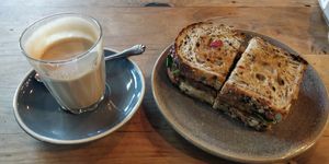 Coffee & toasted tempeh, satay, kraut sandwich at Friends of the Earth Cafe in Collingwood