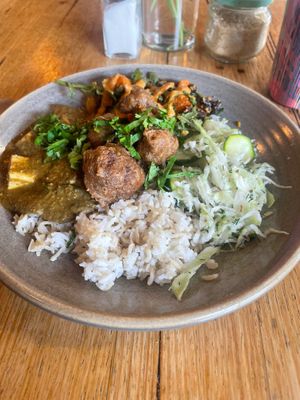 tofu curry, black bean sweet potato, sauerkraut, rice and cauliflower fritters at Friends of the Earth Cafe in Collingwood