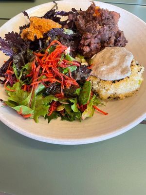 large salad bowl with: tofu millet croquette,  salad, broccoli with satay and black bean sweet potato stew  at Friends of the Earth Cafe in Collingwood