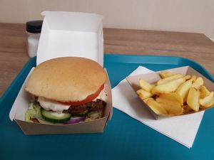 Double D burger with fries at Epoch Vegan Burger in Budapest