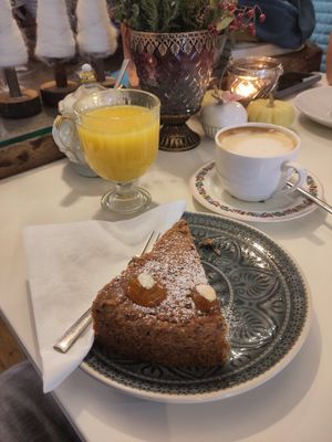 Fresh-pressed orange juice, flat white, vegan cake at Cafe im Süden in Bad Toelz