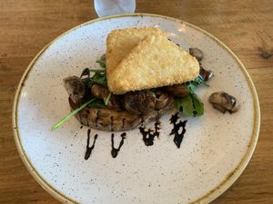 Sautéed mushrooms with spinach on toast and hash browns   at Monica's Cafe in Maleny