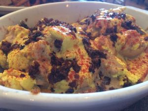 Breakfast benny special, english muffin, house-made mozz, tofu, topped with vegan hollandaise, crispy mushrooms, and swimming in gravy.   at The Gold Leaf in Fort Collins