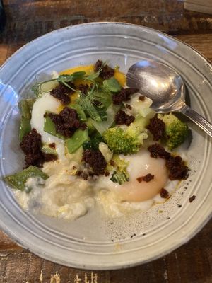 Poached eggs with veges, polenta, cream sauce  at Lluvia in Alicante