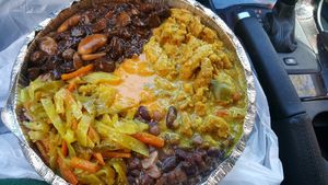 medium with 2 proteins (curry chickn, Brown stew) and 3 sides (rice and peas, cabbage, 9 bean stew) and homemade hot sauce  at Ninth Square Market Caribbean Style in New Haven