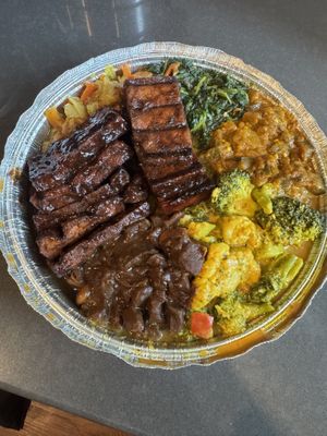 Jerk tofu, brown stew chunks, cabbage, curry mixed vegetables, sautéed greens, and stewed eggplant  at Ninth Square Market Caribbean Style in New Haven
