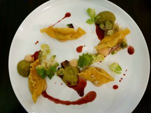 Homemade ravioli stuffed with celery cream and bengal pepper on granny smith paste with romanesco at Farbenfroh in Essen