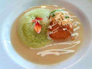 Dough ball filled with herbs in a creamy apple soup at Farbenfroh in Essen