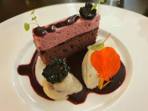 White chocolate praline with blackberry centre, blackberry cake & chamomile mousse at Farbenfroh in Essen