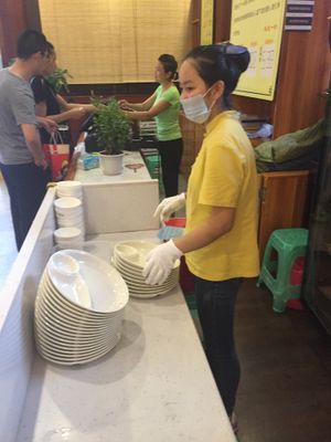 Pay counter and ticket exchange (you exchange your ticket for a plate, bowl, and chopsticks.) at Qiānhé Qīngxīn 谦和清心素食 - 温江店 in Chengdu