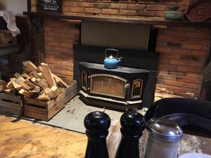 The main dining area is heated by an old fashioned wood burning stove.  at Horn O Plenty in Bedford