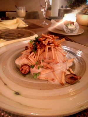 Hiding under all that sauce is a potato dish.  at Mandala in Belgrade