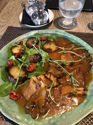 Sweet oyster mushrooms with bbq sauce and grilled potatoes on the salad  at Mandala in Belgrade