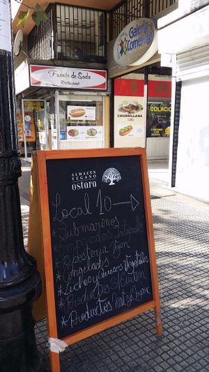 Sign on footpath at Almacen Vegano Ostara in Santiago