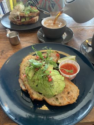 seriously good😍 avo toast complimented nicely by pomegranate seeds and chilli jam. my partner enjoyed his full english esp the chipotle beans! good vibes- def recommend! at The Curious Kitchen in Brixham