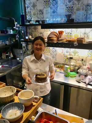 Sophie with her delicious chocolate cake at Blossom Rena Vegan Cafe 貝多蕾納 in Taipei