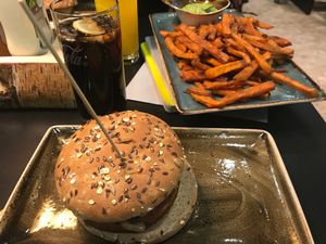 Angerling burger with mushrooms and 3-pepper sauce, served with sweet potato fries and guacamole. at MUC - Hans im Glück - T2 in Munich