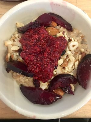 Sweet Morning Bowl (warm oatmeal w. different types of berries, nuts and coconut)  at Nourish Cafe in San Francisco