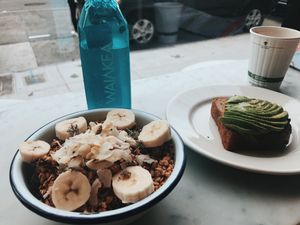 Acai Bowl with granola and banana, as well as avocado toast at Nourish Cafe in San Francisco