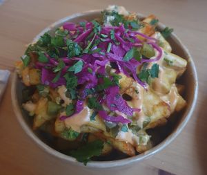 (Ninas taco truck) Dirty fries: seasoned fries topped with cheeze sauce, jalapeños, red cabbage, crispy onions and chipotle mayo  #Veganuary at GRUB in Manchester