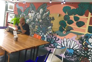 Outdoor seating area with graffiti art at Padoca Vegan in Sao Paulo