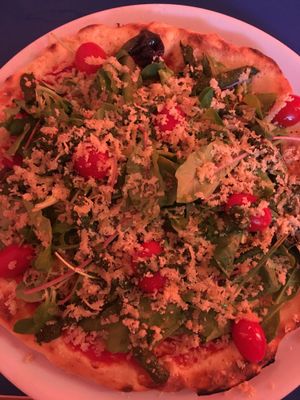 Tomato, rocket salad, pesto, and vegan Parmesan cheese pizza at Mastino V in Amsterdam