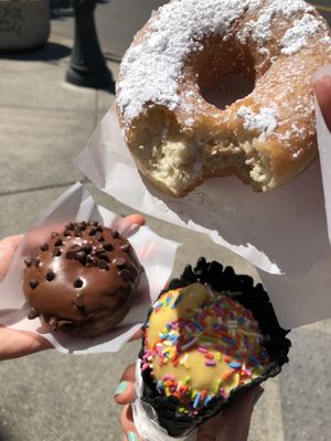 (Top) French toast doughnut, (bottom) zucchini chocolate cake doughnut, passion fruit ice cream in a charcoal waffle cone  at Doe Donuts in Portland