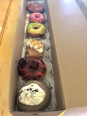 (Top to bottom) guava pineapple fritter, doe, sour yuzu + green tea, banana cream pie, chocolate raspberry cream pie, Portland fog  at Doe Donuts in Portland