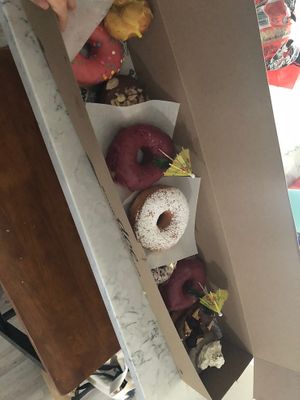 Blackberry mint, doe (strawberry), chocolate almond cake, French toast. Part of a dozen.  at Doe Donuts in Portland