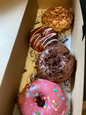 From top: Peanut butter bacon, red velvet, brownie batter, Doe (strawberry milk) at Doe Donuts in Portland
