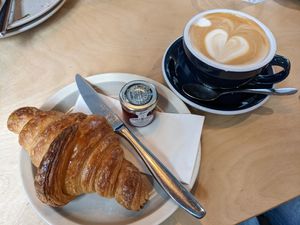 Oat milk latte and vegan croissant at Academy in Winchester