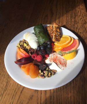 Mediterranean Breakfast - Dried fruit & nuts, fresh fruit, yogurt, hard-boiled egg, olives, chard dolma, zatar focaccia at Mediterranea Restaurant & Bakery in Atlanta
