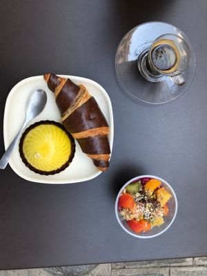 Chocolate croissant, citrus dome, acai cup, espresso at Laelo in Paris