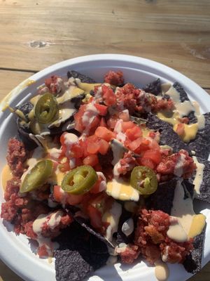 Nachos - they were out of black beans and avocado, so they threw some crumpled burger patty on top.  at Moab Kitchen in Moab